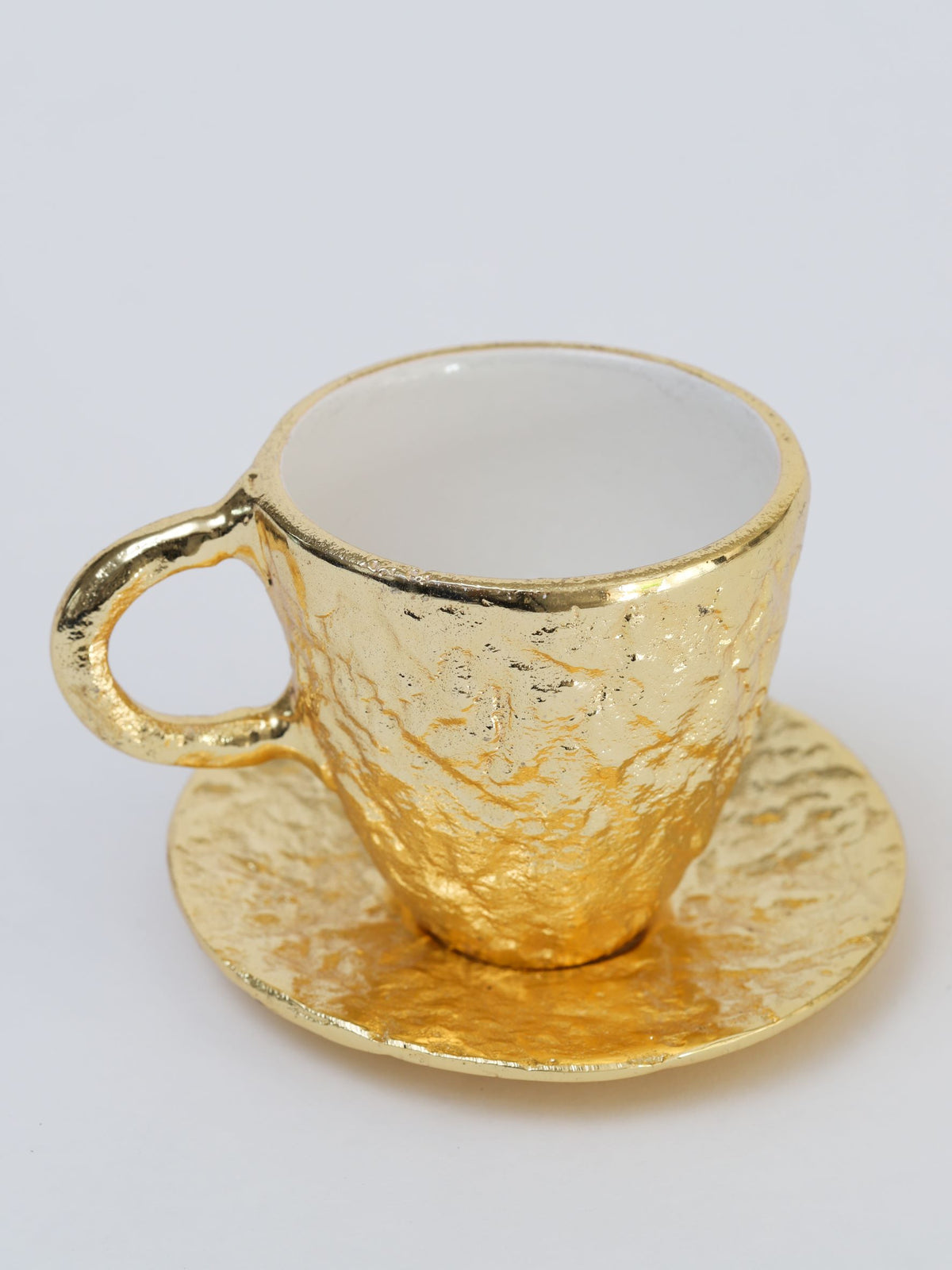 https://www.shopinspiremehomedecor.shop/wp-content/uploads/1693/26/gold-textured-metal-tea-cup-and-saucer-with-white-interior-inspire-me-home-decor-explore-a-world-of-possibilities-take-a-look-at-our-extensive-selection_1.jpg