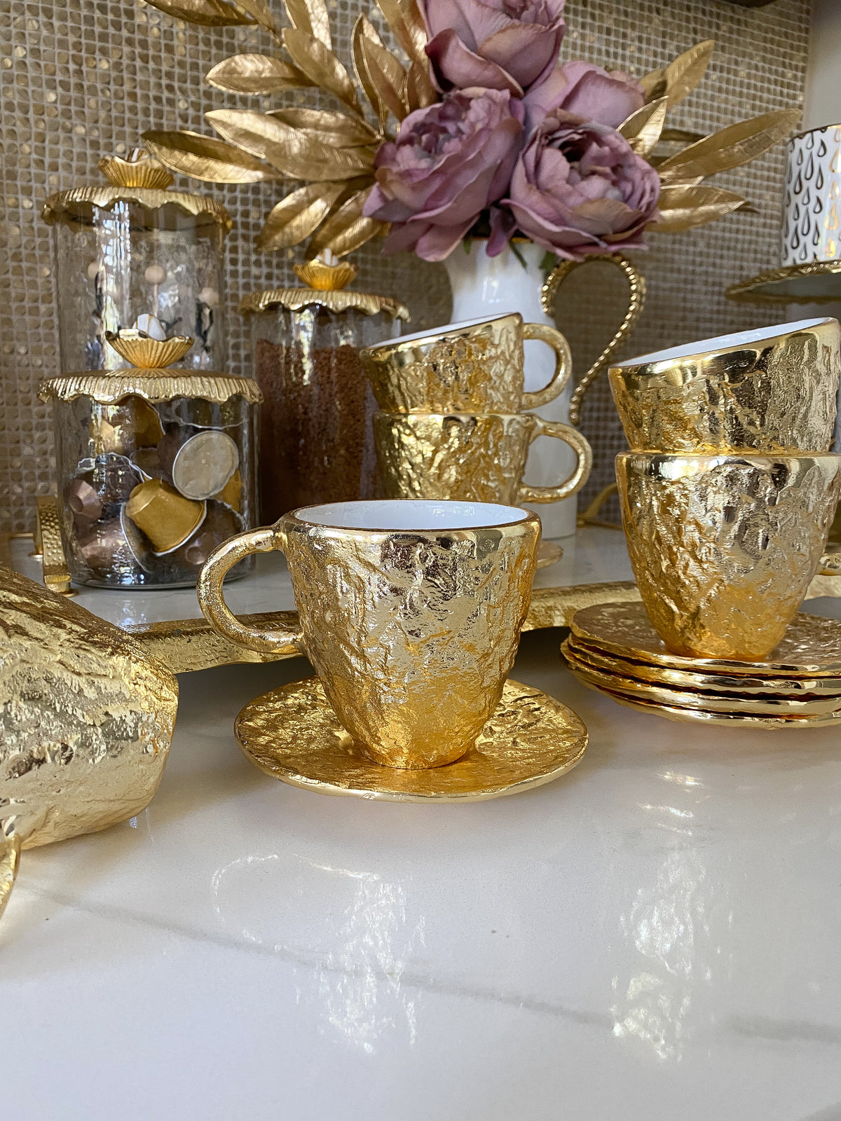 https://www.shopinspiremehomedecor.shop/wp-content/uploads/1693/26/gold-textured-metal-tea-cup-and-saucer-with-white-interior-inspire-me-home-decor-explore-a-world-of-possibilities-take-a-look-at-our-extensive-selection_4.jpg